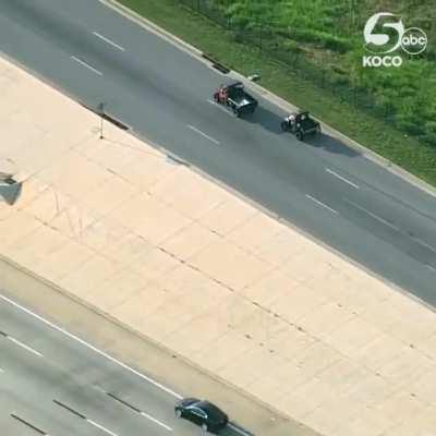 Helicopter footage of a loose cow being wrangled by Emergency Services and cowboys in OKC