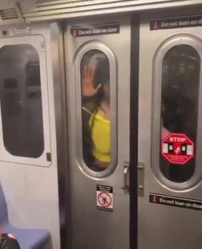 A couple having sex in between two train cars.