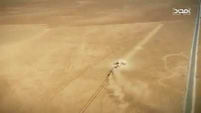 Tank firing a shell in desert creating the shell train on sand