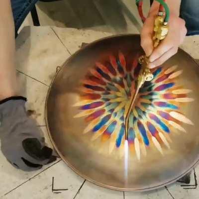 Making art from flame on a copper surface