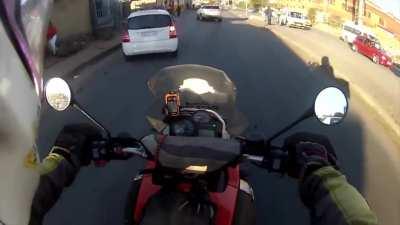 A man uses his motorcycle to stop a robbery.