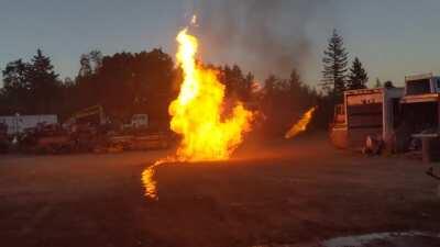 What happens when you shoot two propane cans that are doused in gasoline and lit on fire