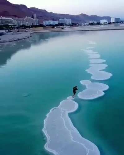 Jogging on salt in the Dead Sea.