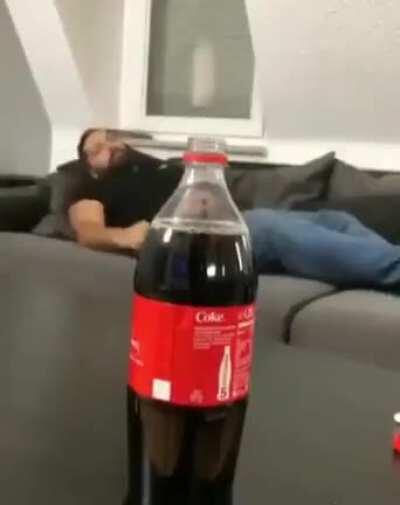 Man deep-throats a coke bottle