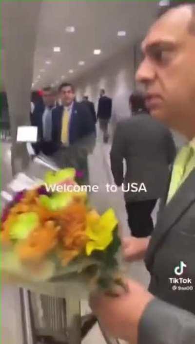 The finance minister of Pakistan and his entourage arrive at an airport in the US