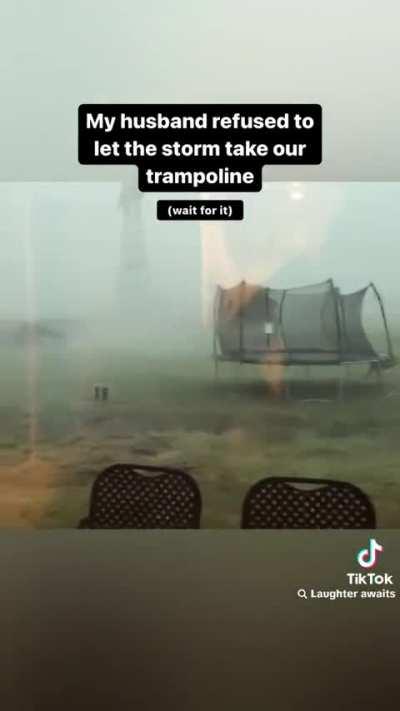 Man tries to save trampoline in a storm