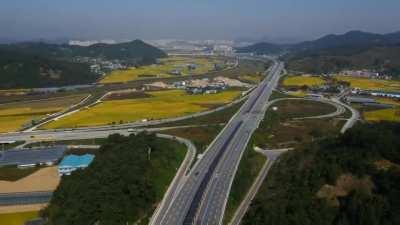 South Korea. The solar panels in the middle of the highway have a bicycle path underneath - cyclists are protected from the sun, isolated from traffic, and the country can produce clean energy.