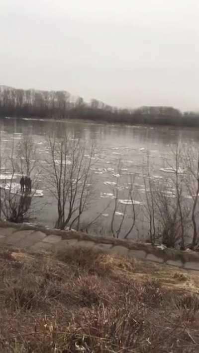 3 kids floating down a river on ice