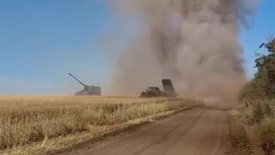 Ukrainian GRAD MLRS battery firing at Russian targets next to a German PzH 2000 artillery gun in eastern Ukraine. 