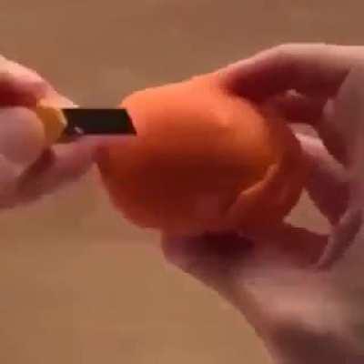 Guy has a neat way of peeling a tangerine