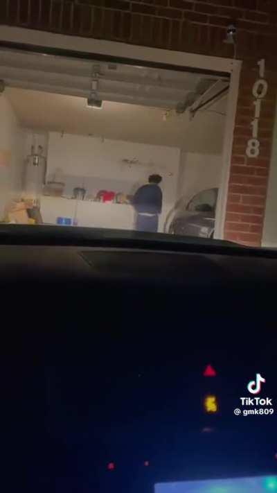 Dude tries to jump over the garage door sensor, ends up on his ass