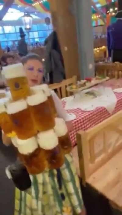 Oktoberfest waitress carries 13 beer mugs