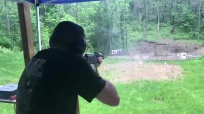 AK-47 muzzle blast deflecting rain.