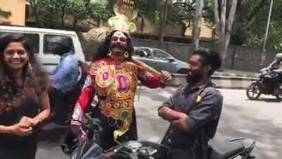 Guy dressed as Yama, god of death, gives free helmets to bikers who aren't wearing one