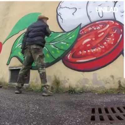 This artist tackles racist graffiti in the most perfect way by covering them with food graffiti