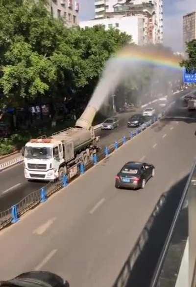 Truck spraying water on the road