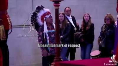 A Canadian First Nations Chief saluting the Queen of Canada’s coffin