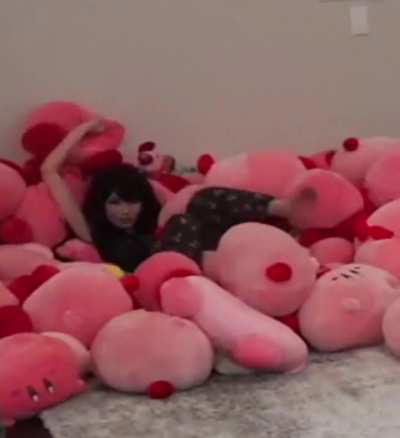 Emiru in her Kirby pile - July 2024