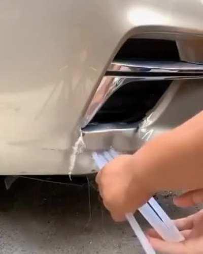 Trying a lifehack to remove a dent