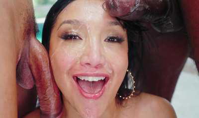 Vicki Chase covered in the cum provided by the cocks on her face.