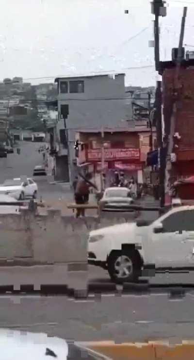 A gang ( terror member ) holding what seems to be a rocket propelled grenade .