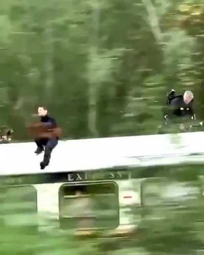 Nothing to see here, just Tom Cruise casually sitting on top of a moving train while shooting for Mission Impossible 7