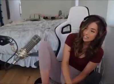 Pokimane showing off her white and pink polka dot socks.