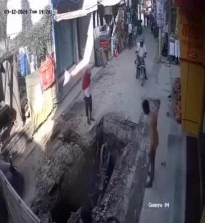 A huge pit in the middle of road