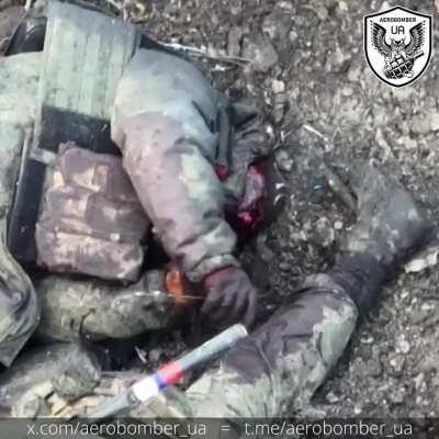 Russian Soldier playing with the leg of another Russian soldier 