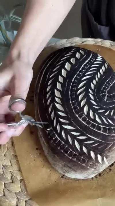 Scoring sourdough bread with black cocoa powder