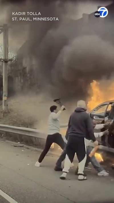 The moment a group of good Samaritans rushed to rescue a driver from a burning car after a crash in Minnesota.