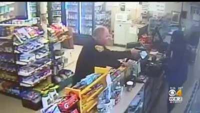 Guy try’s to rob a store with cop in it