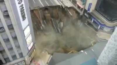 Road collapse in Hakata, Japan on 8 November, 2016. The gigantic hole in downtown Fukuoka, southern Japan, cutting off power, water and gas supplies to parts of the city.