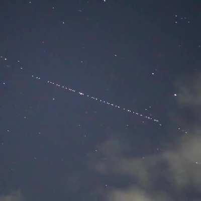 A train of SpaceX Starlink satellites seen travelling high over Japan