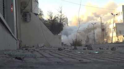 Syrian Rebels detonate explosives under and collapse a high rise being used as a firing point by the SAA - Babbila, Syria - 10/27/2013