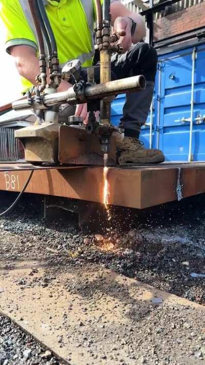 Oxy-fuel torch cutting a 112 mm (4.4 in) thick steel plate