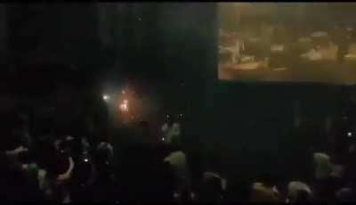 Audience lit fireworks inside a theater to celebrate entry of movie star