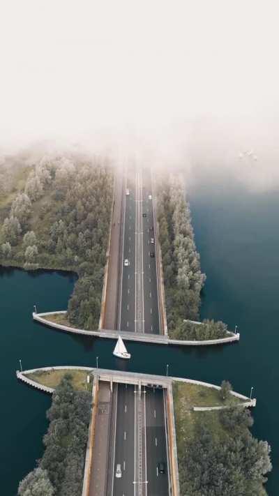 Sailboat crossing the Veluwemeer Aquaduct, Netherlands