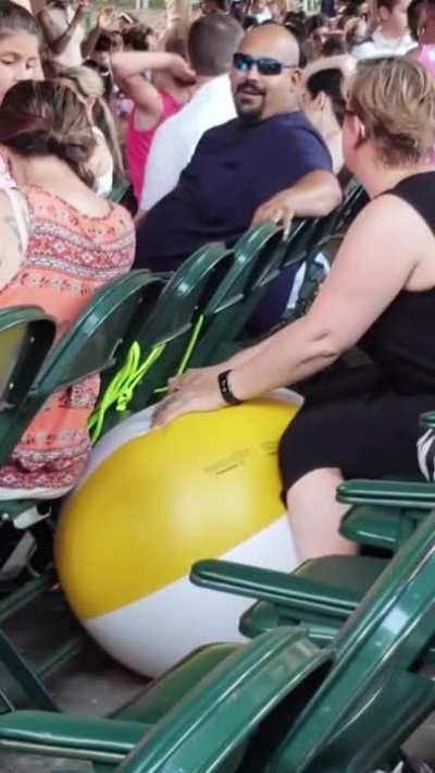 Lady deflating beachballs at a children’s concert