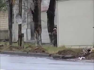 Chechen rebels running down the street and shooting wildly are shot by Russian soldiers