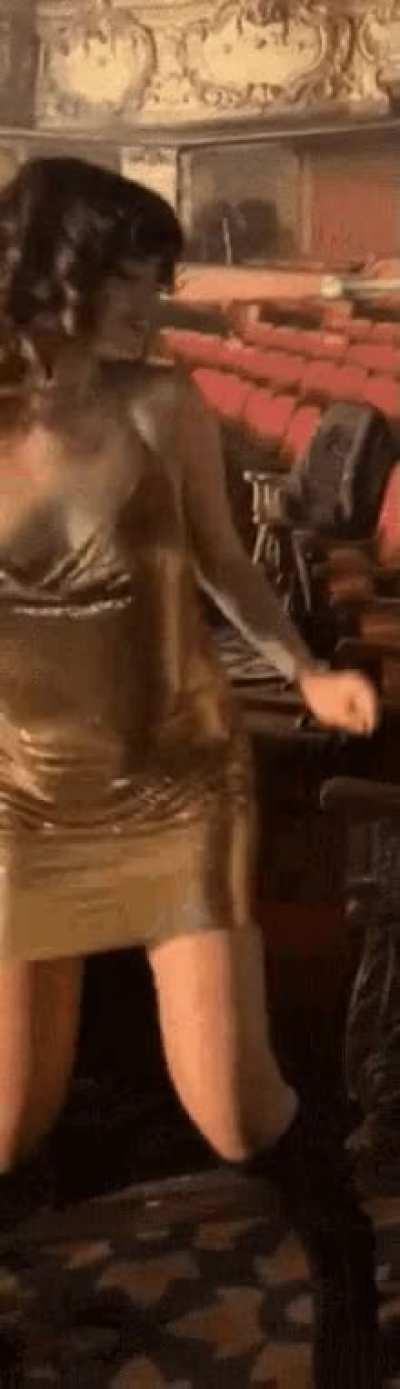 The gold dress shows off her amazing figure and breast