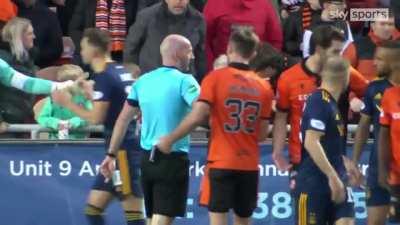 Funso Ojo was sent off after an altercation with a Dundee United supporter who shoved the Aberdeen midfielder.