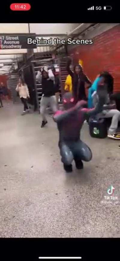 Spider-Man showing awesome dance moves at the subway station