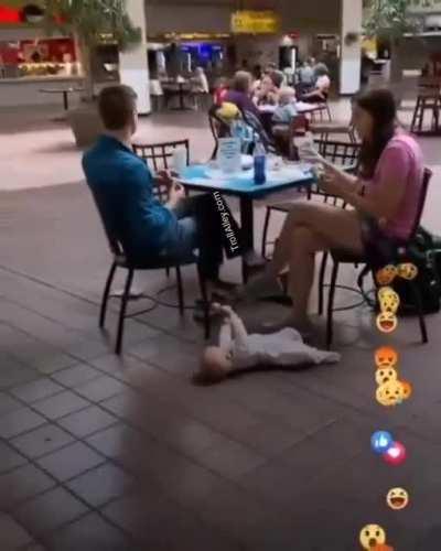 Parents leave baby on the floor at mall cause they didn't have a booster seat.