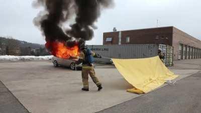 A fire blanket is a highly flame-resistant blanket that can be used to extinguish a small fire by cutting off oxygen to the fire source.