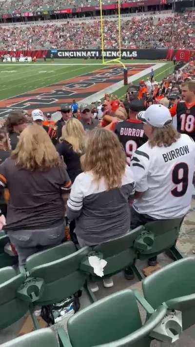 Girls fight as guy who later head butts another guy while cuffed is escorted out of Bengals game.