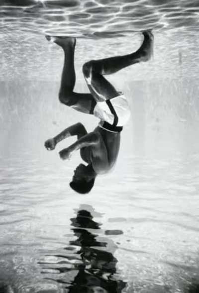 Mohammed Ali standing at the bottom of a pool