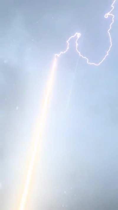 Lightning Bolt Is Guided To Ground Through Rocket Trail