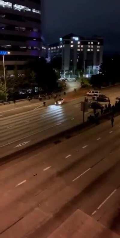 Two Seattle protestors getting run over by a car on the highway