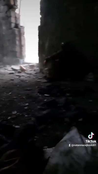 Ukrainian troops in Avdiivka take cover inside a building while artillery and cluster munitions fall outside